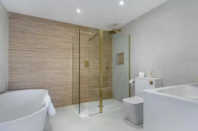 a bathroom with a shower and a toilet and a sink at 6 Bed in High Lanes oc-r29370 in Little Petherick