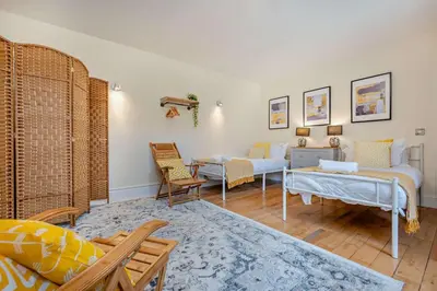 a living room with two beds and a couch at 4 Bed in Newquay oc-w29346 in Newquay