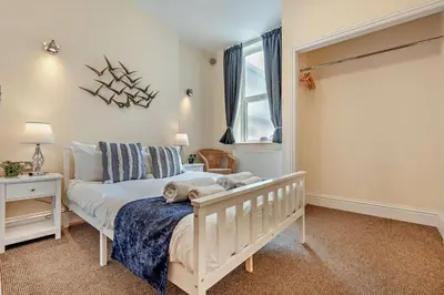 a bedroom with a white bed and a window at 4 Bed in Newquay oc-w29346 in Newquay