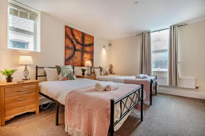 a bedroom with two beds and two windows at 4 Bed in Newquay oc-w29346 in Newquay