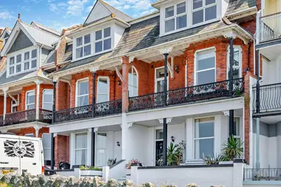 a row of red brick houses with balconies at 4 Bed in Newquay oc-w29346 in Newquay