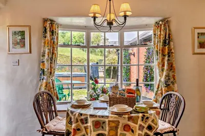 a dining room with a table and a large window at 1 Bed in Duloe oc-b29367 in Duloe