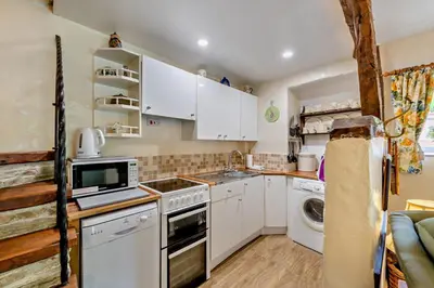 a kitchen with white cabinets and a stove top oven at 1 Bed in Duloe oc-b29367 in Duloe