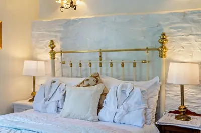 a bedroom with a bed with blue blankets and pillows at 1 Bed in Duloe oc-b29367 in Duloe