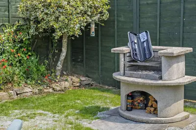 a stone oven with a clock on top of it at 1 Bed in Duloe oc-b29367 in Duloe