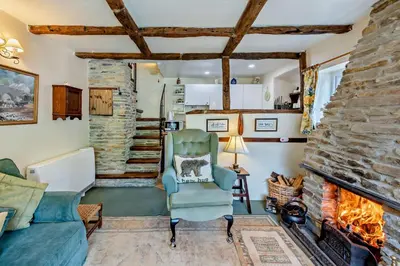 a living room with a couch and a fireplace at 1 Bed in Duloe oc-b29367 in Duloe
