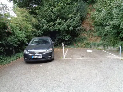 a black car parked in a parking lot at Jordan Cottage in Fowey