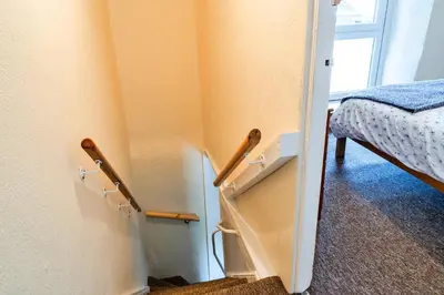 a room with a door with a stairway leading to a bedroom at Finest Retreats - Cutkieve Farm Cottage in Middlehill
