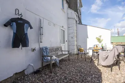 a shirt hanging on a wall next to a table at May Cottage in St Ives