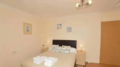 a bedroom with a bed with two pillows on it at Beach View House - Self Catering Hayle, St Ives Bay Cornwall in Hayle