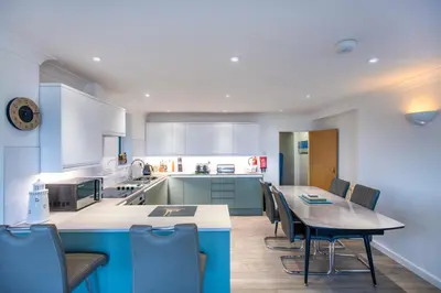 a kitchen and dining room with a table and chairs at Beach View House - Self Catering Hayle, St Ives Bay Cornwall in Hayle