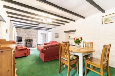 a living room with a table and chairs at Lolgorien, West Cornwall, Sleeps 8 in Camborne