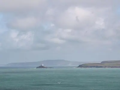 a lighthouse on an island in the middle of the ocean at Talland View in St Ives