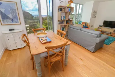 a living room with a table and chairs and a couch at Talland View in St Ives