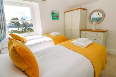a bedroom with two beds and a window at Hindon Hall in St Ives