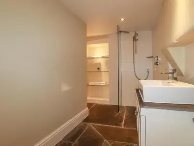 a bathroom with a sink and a shower at Carew House Cottage in Redruth
