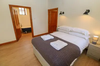 a bedroom with a bed with two towels on it at The Granary in Penzance