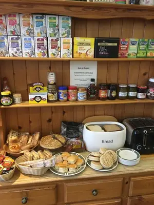 a shelf filled with lots of different types of food at The Quies in Newquay