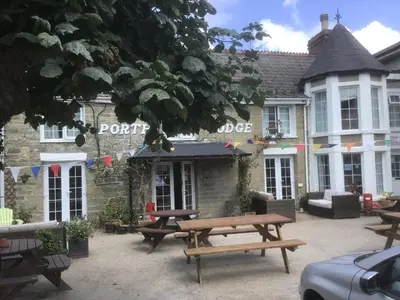 a picnic table in front of a building at Porth Lodge in Newquay