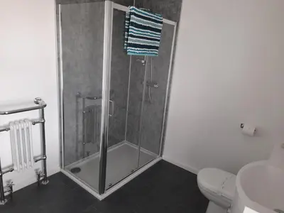 a shower stall in a bathroom with a toilet at Tregella Guest House in Newquay