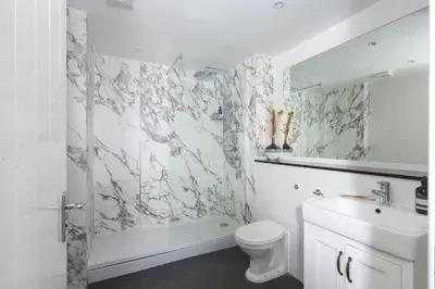 a bathroom with a toilet and a sink and a shower at 4 Glendorgal Sands, Newquay in Newquay