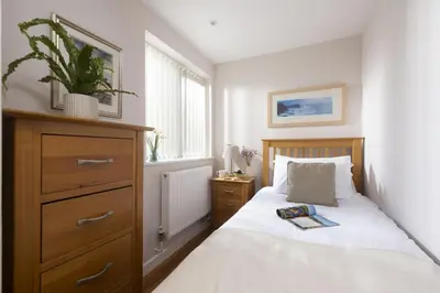 a bedroom with a bed with a plant on it at 4 Glendorgal Sands, Newquay in Newquay