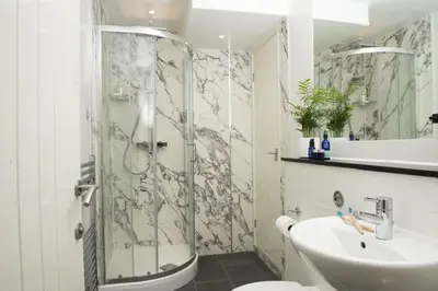 a bathroom with a shower and a sink at 4 Glendorgal Sands, Newquay in Newquay