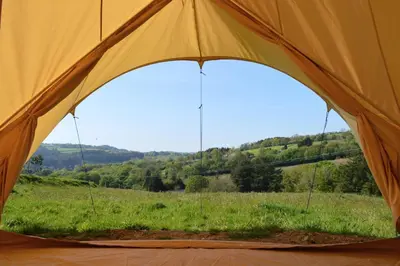 an orange tent with a view of a field at Luxury Glamping - Heydaze in Lostwithiel