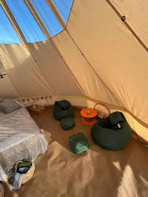 a tent with two beds and a table in it at Luxury Glamping - Heydaze in Lostwithiel