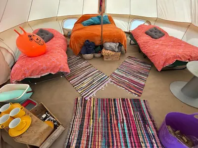 a group of four pillows and blankets on a floor with ties at Luxury Glamping - Heydaze in Lostwithiel