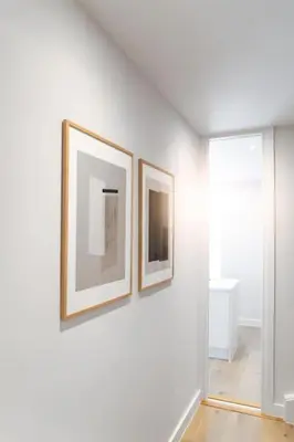 two framed pictures on a white wall in a room at Luxury Waterfront 3 Bedroom/3 Bathroom Townhouse in Hayle