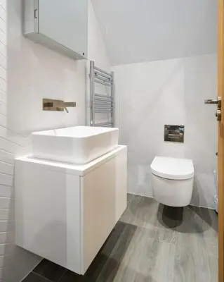 a white bathroom with a sink and a toilet at Luxury Waterfront 3 Bedroom/3 Bathroom Townhouse in Hayle