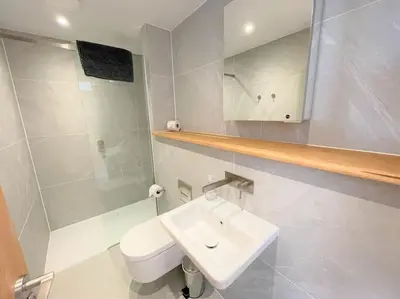 a white bathroom with a sink and a toilet at Luxury Waterfront 3 Bedroom/3 Bathroom Townhouse in Hayle