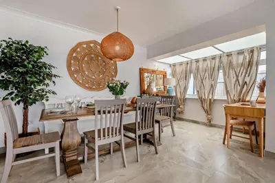 a dining room with a table and chairs at 3 Bed in Downderry oc-s29364 in Downderry