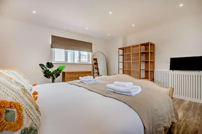 a bedroom with a large white bed with two towels at 3 Bed in Downderry oc-s29364 in Downderry