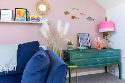 a living room with a blue couch and a green dresser at 3 Bed in Mawgan Porth oc-s29403 in Mawgan Porth