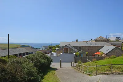 a group of houses on a hill with a road at 3 Bed in Mawgan Porth oc-s29403 in Mawgan Porth
