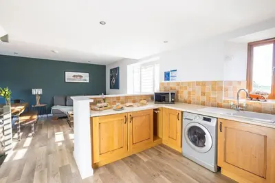 a kitchen with a washer and dryer in it at 3 Bed in Mawgan Porth oc-s29403 in Mawgan Porth