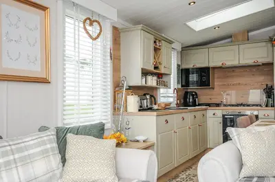 a living room with a couch and a kitchen at Polperro Road in Looe