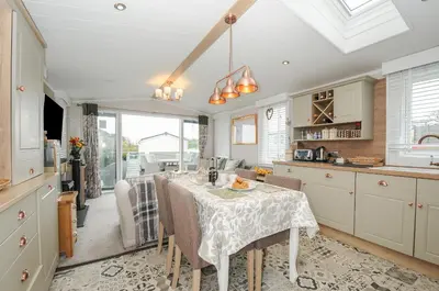 a kitchen with a table and chairs in a kitchen at Polperro Road in Looe