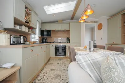 a kitchen with a couch and a table in a room at Polperro Road in Looe