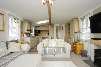a kitchen with two chairs and a couch in a room at Polperro Road in Looe