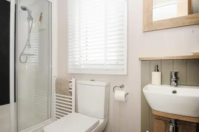 a bathroom with a white toilet and a sink at Polperro Road in Looe