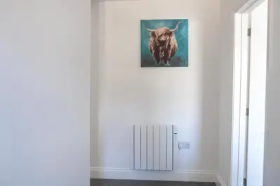 a picture of a bull hanging on a wall at No.9 Priory House, Bodmin in Bodmin