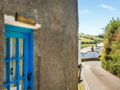a blue door on the side of a building at Mermaid Cottage - Uk47403 in Portmellon