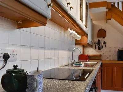 a kitchen with a sink and a counter top at Mermaid Cottage - Uk47403 in Portmellon