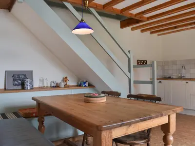 a kitchen with a wooden table in a room at Corner Cottage - Uk47402 in Portmellon