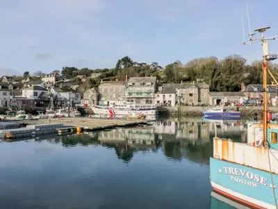 a boat docked at a dock in a harbor at The Willows in Saint Columb Major