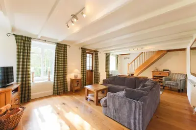a living room with a couch and a table at November Cottage St Kew, North Cornwall Cosy Cottage in Bodmin