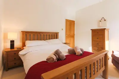 a bedroom with a large bed with two pillows on it at November Cottage St Kew, North Cornwall Cosy Cottage in Bodmin